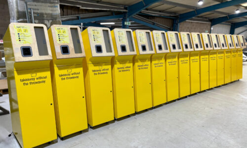 Metal kiosks powder coated yellow and assembled integrating non-sheet metal components such as plastics, wood, and graphics