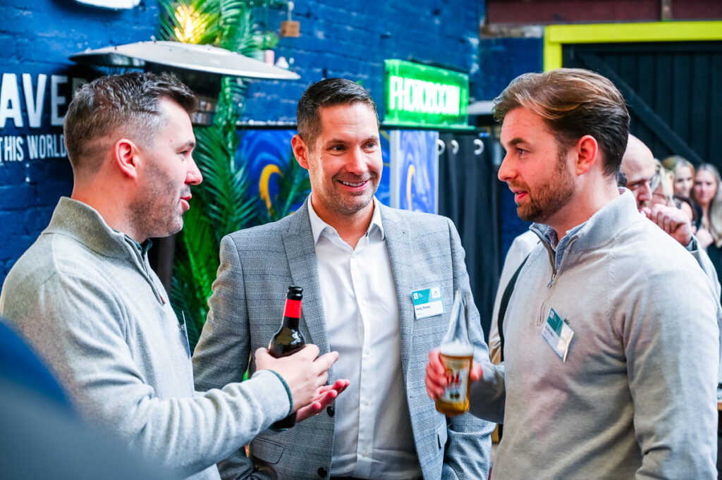 Photo of 3 men networking at an informal business event